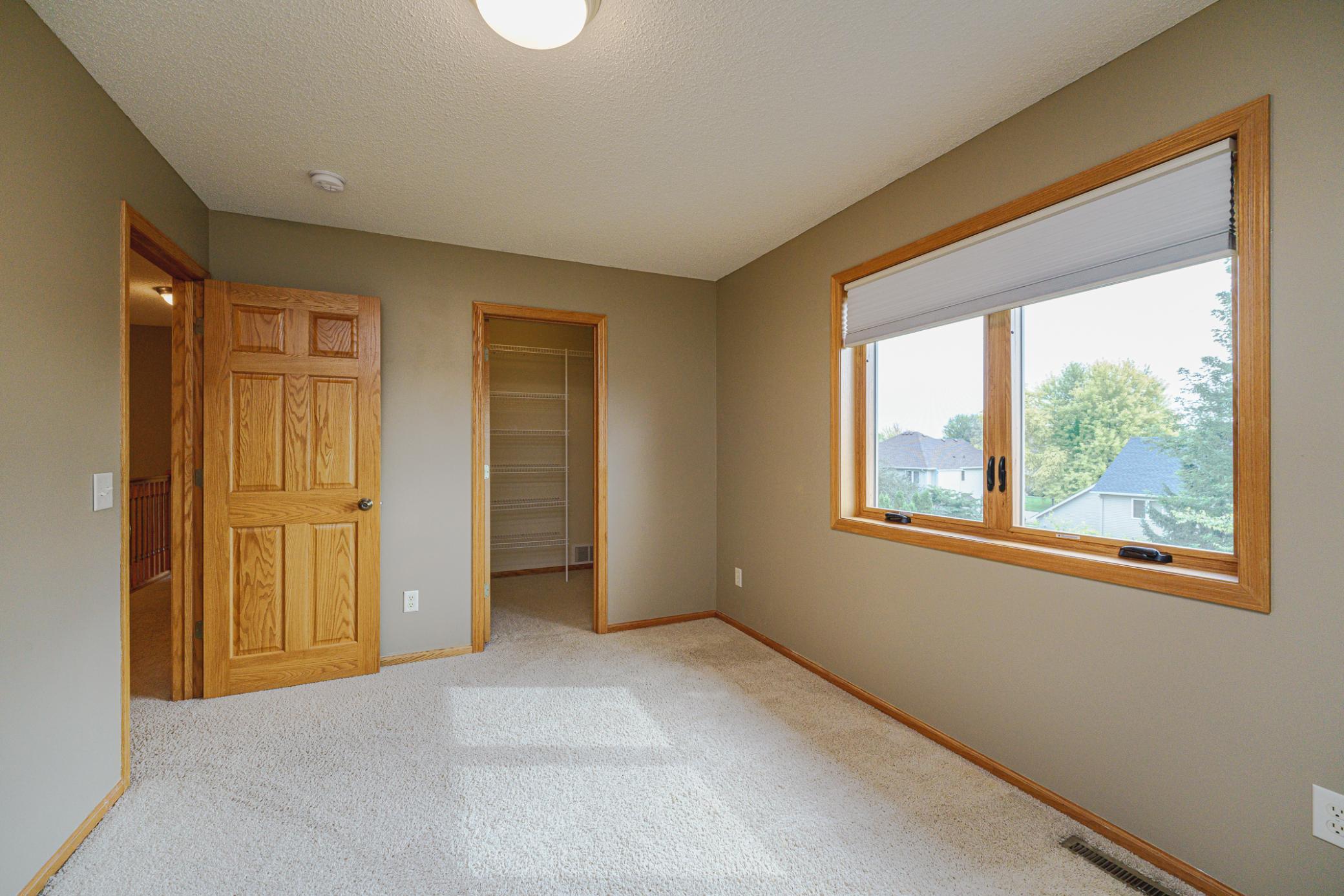 This is one of three upper level bedrooms and it has a walk-in closet.