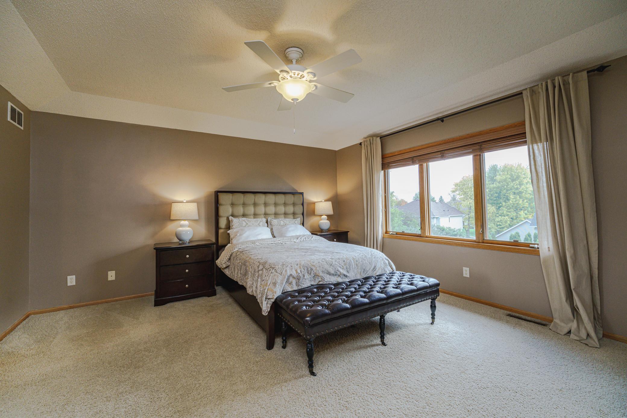 The owner’s suite is vaulted and includes a ceiling fan.