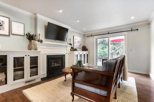 Family Room with stained glass built-it cabinets, gas fireplace, and walkout to fenced backyard
