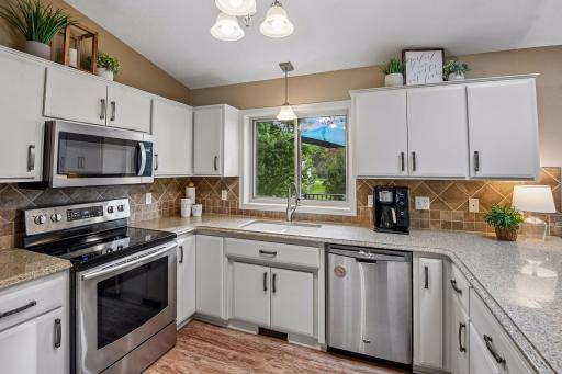 Granite countertops and stainless steel appliances.