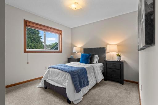 Second bedroom on the upper level overlooking the side yard.