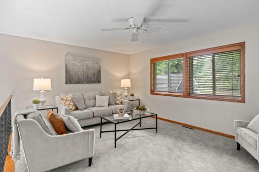 Upper level living room flooded with natural light, overlooking the main level.