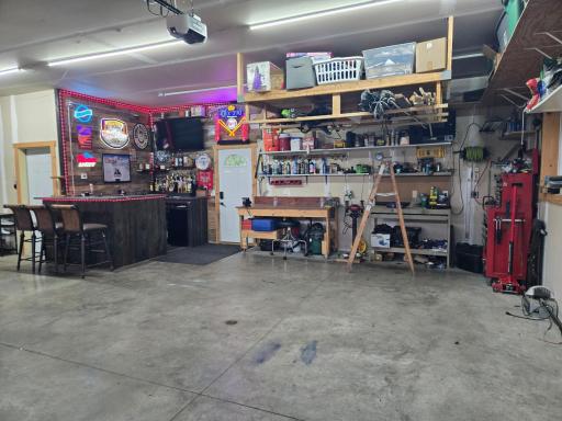 Garage features a dry bar and has in floor heat with floor drain