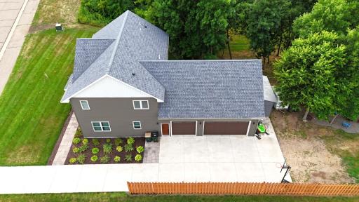 Beautiful concrete drive with pavers surrounding mature landscaping.