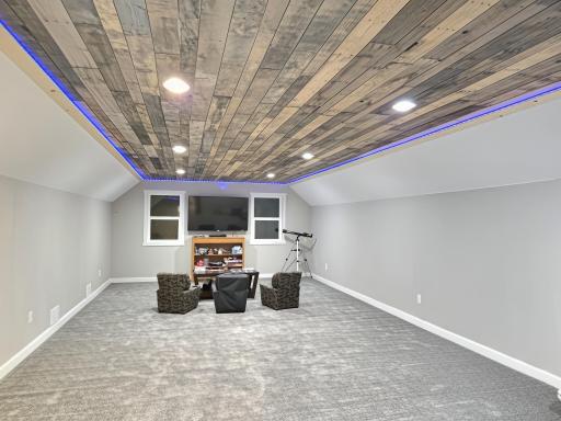 Expansive bonus room above the garage. Setup as movie room, craft area or expand your private workout studio