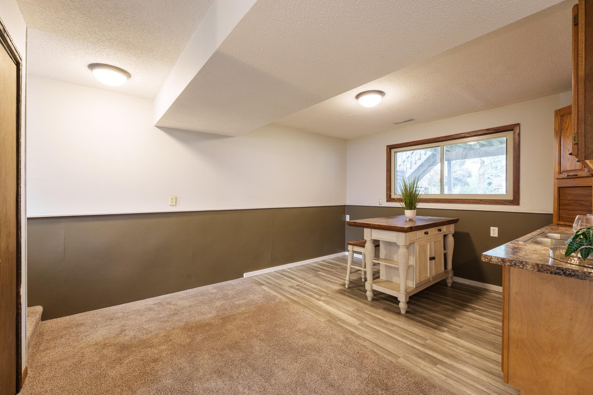 The lower level adds a second comfortable living space with a family room, wet bar, two additional bedrooms, and a ¾ bathroom.