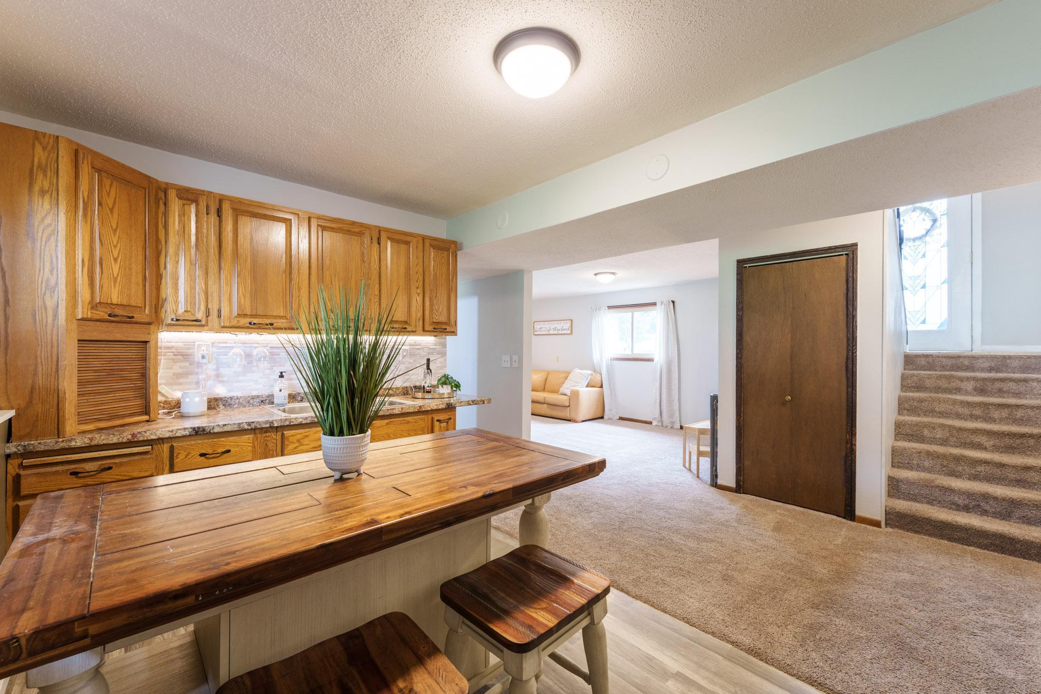 Enjoy this inviting wet bar- perfect for playing cards with friends and family, hosting guests, or creating your own cozy space for entertaining.