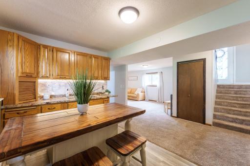 Enjoy this inviting wet bar- perfect for playing cards with friends and family, hosting guests, or creating your own cozy space for entertaining.
