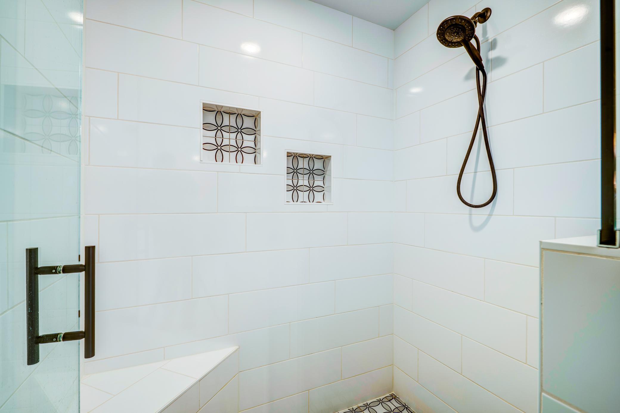 Custom built large tiled walk in shower in the primary suite