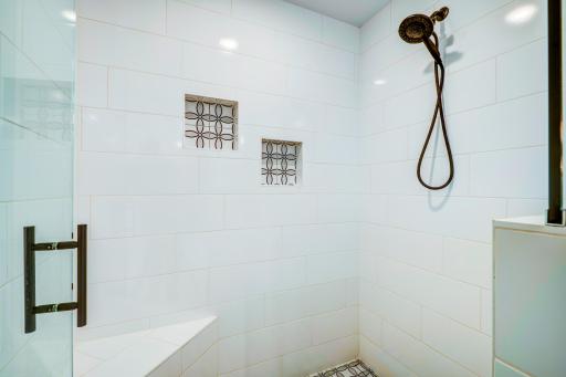 Custom built large tiled walk in shower in the primary suite