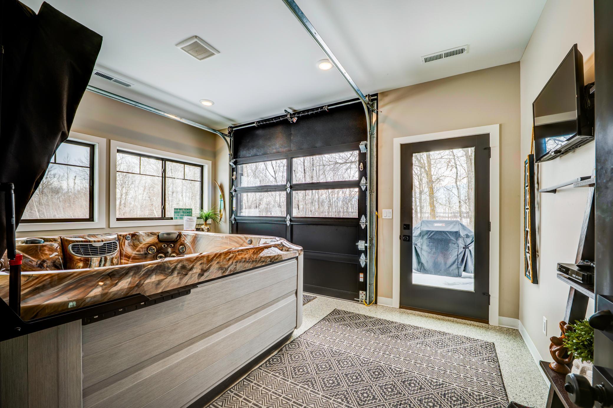 The sun room is a beautiful finished living space just off of the living room. The garage door is great for bringing large items in and also for enjoying the weather!