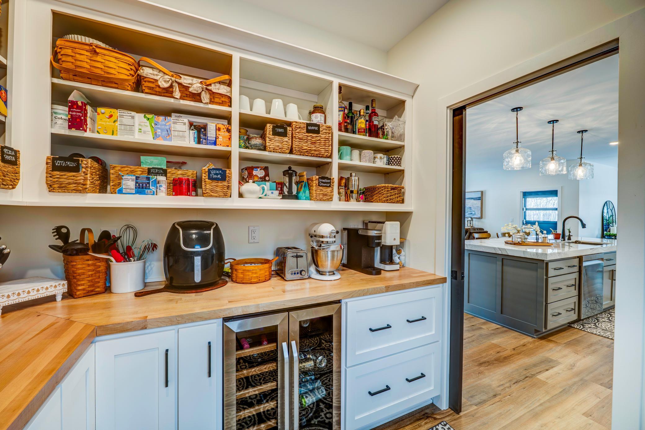 Just off of the kitchen is the Butler's pantry, cleverly hidden with a pocket door