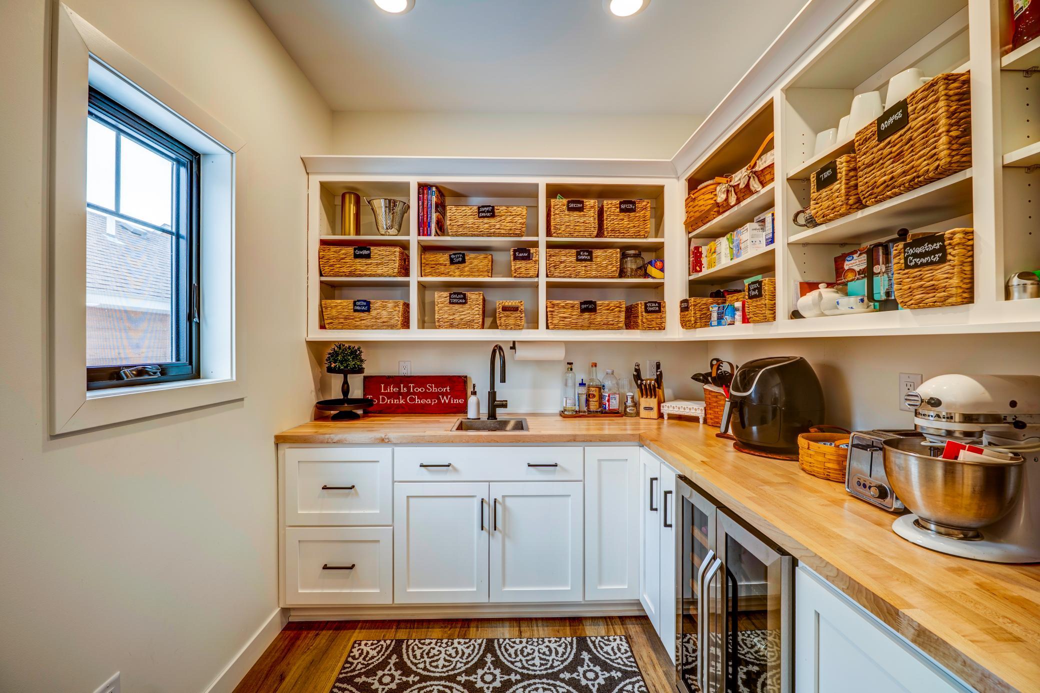 A Butler's pantry- complete with a sink, lots of storage and a wine cooler is the chef's kiss