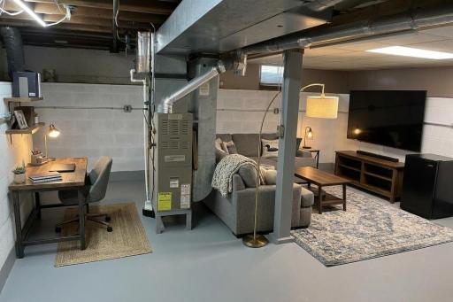 AI photo staged of basement family room with office. (scenario 1)
