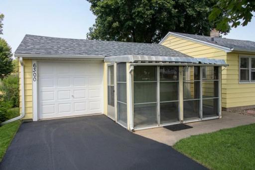 Attached garage and screened in 3 season porch That can be used for relaxing or an area for your plants.