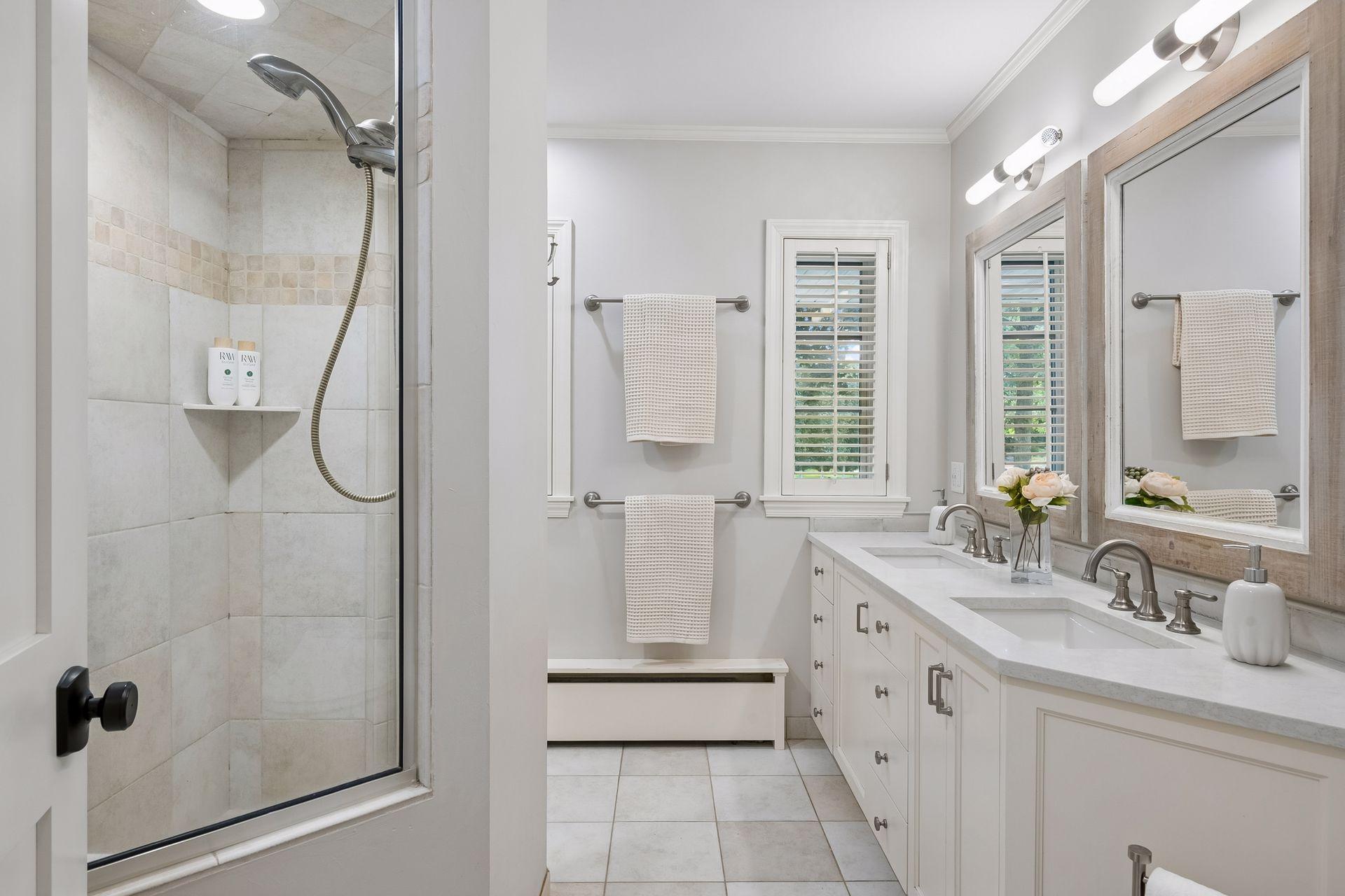 Private 3/4 primary bath with double vanity and walk-in shower