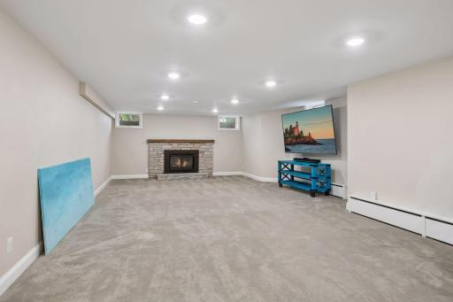 The ultimate hangout spot- a sprawling 35x15 recreation zone featuring a brand-new wet bar, space for games and a cozy set-up for home theater.