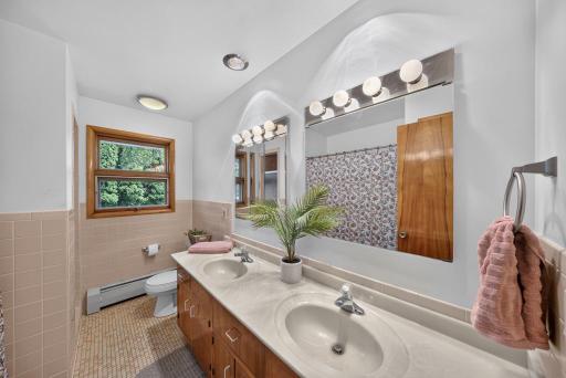 Full main level bath that has dual sinks, stand alone tile showed, full bath.