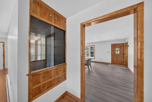 From the hallway looking out to the front door, entry way closet, built in hutch. To the right is the hallway for the 4 bedrooms, and full bath as well as extra closet storage space!