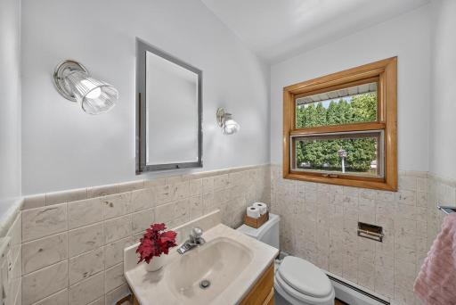 1/2 bath that looks out to the flat back yard on almost 1/2 acre. When youre working in the garage or playing in the back you don't have to go thru the whole house to go to the bathroom. 1st door to your right when you come in from the garage.