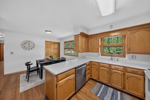 The kitchen has windows that look out to the back flat almost 1/2 acre yard. Dining room set for 4, table can extend OR consider making it a breakfast nook and the large dining in part of the living room. Options! Lots of counter space!