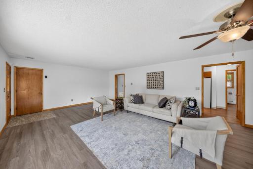 Updated flooring and large front room with lots of possibilities. Also can see the half bath which is to the right when you come inside from the garage.