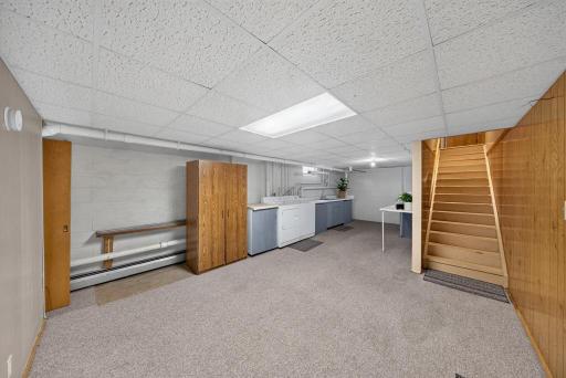 Spacious laundry room. At the top of the stairs a right takes you to the front room, the left to the 1/2 bath and garage door.