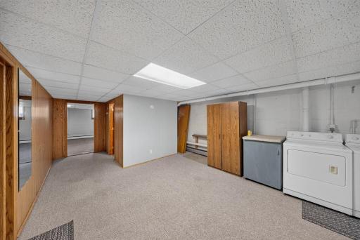 At the bottom of the stairs, straight ahead is the family room, straight ahead and to the right is the 3/4 bath, to the left is the game room, work shop or storage room and currently in the spacious laundry room!