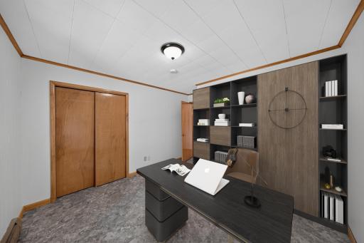 Virtually staged room. This could be a 4th bedroom on the main level or an office which is virtually staged here. The wall unit behind the desk if virtually staged. Would make a great office, toy room, 4th bdrm, or gym space...