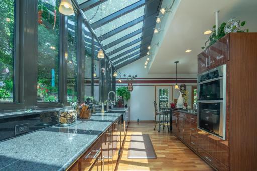 Unique kitchen with stainless steel appliances. Door leads directly to greenhouse