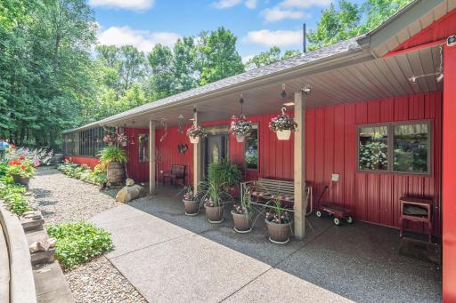 Front entry with numerous potted flowers