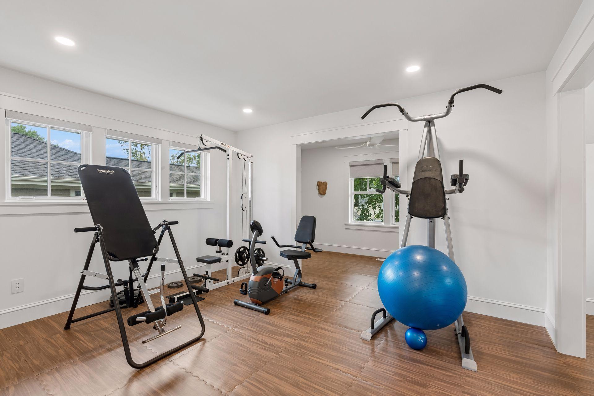 large upper level bunk room being used as an exercise room
