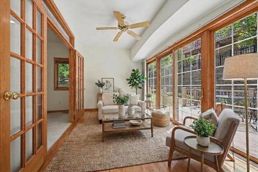 South-facing sunroom filled with natural light and connected to the maintenance-free deck. (virtually staged to show potential)