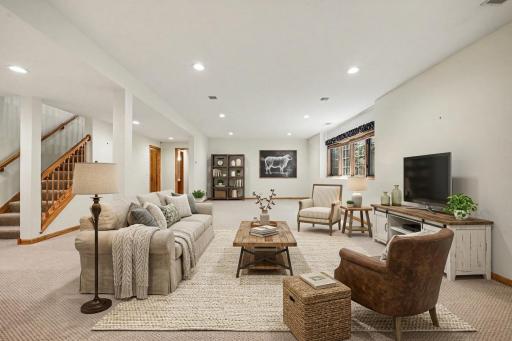 Finished lookout lower level family room with fireplace, wet bar, and space for everyday living or guests. (virtually staged to show potential)