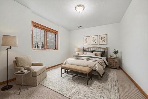 Lower level bedroom with flexible layout potential for guests or extended stays. (virtually staged to show potential)