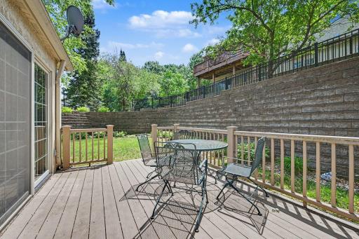 Maintenance-free deck overlooking mature trees and a peaceful backyard setting.