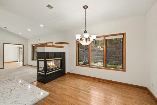 Dining area with hardwood floors, gas fireplace, and easy access to the kitchen.