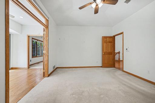 Main-level primary bedroom with nearby sunroom access and private bath.