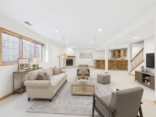 Finished lookout lower-level family room with fireplace and flexible gathering space.