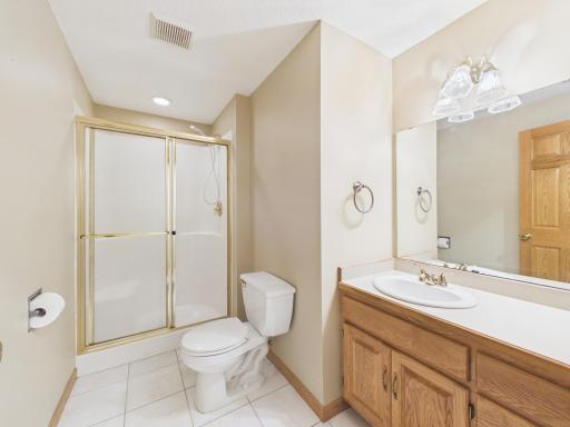 Finished lower-level three-quarter bath serving the family room and guest bedroom.