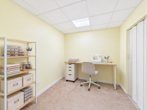 Finished lower-level hobby room, virtually staged to show home office and craft-area potential.
