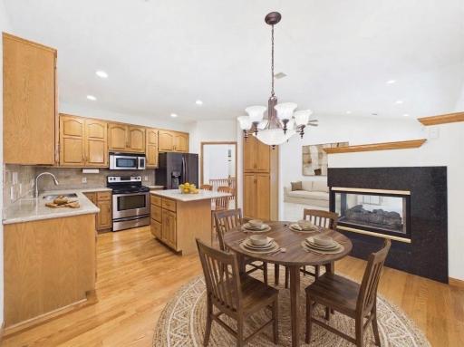 Informal dining area beside the kitchen, virtually staged to show furniture placement and everyday dining potential.