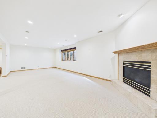 Lookout lower-level family room with gas fireplace and room for everyday living.