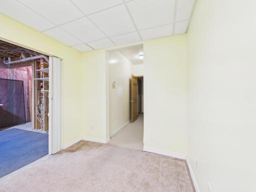 Lower-level hobby room with adjacent storage access for projects, office use, or organized overflow.