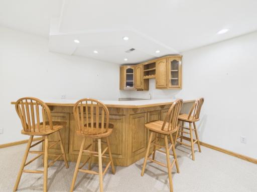 Wet bar in the finished lower level, located near the fireplace and family room.