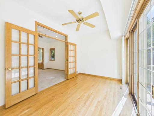 Sunroom with double-door connection to the main-level primary bedroom