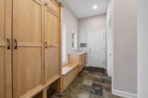 Heading to the other end of the house, you'll find the ultimate mudroom space. Not pictured is a spacious walk-in storage closet and separate kitchen pantry. The door in this photo leads to the oversized garage.
