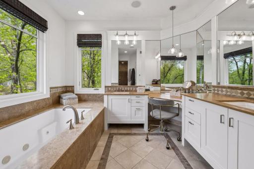 The spa-like primary bathroom features dual-sink vanities (just enameled in 2026), a jetted tub, and a luxurious steam shower.