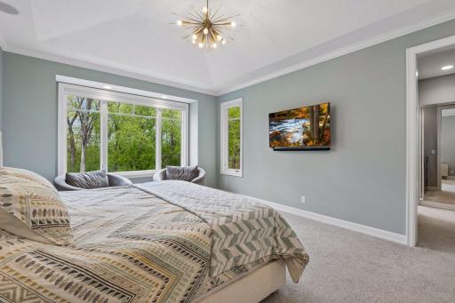 The primary wing of the home is located on the main level, and boasts incredible views of the back yard, a trayed-vault ceiling, and a tranquil feel.