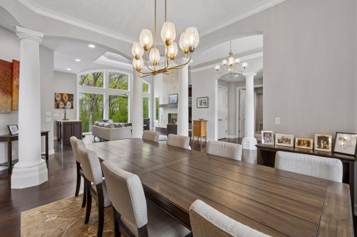 With ten-foot ceilings throughout the main level, the open floorplan feels bright and welcoming (new interior lighting throughout in 2026). Note the lush green views through every window.